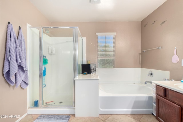 bathroom with vanity, tile patterned floors, and plus walk in shower