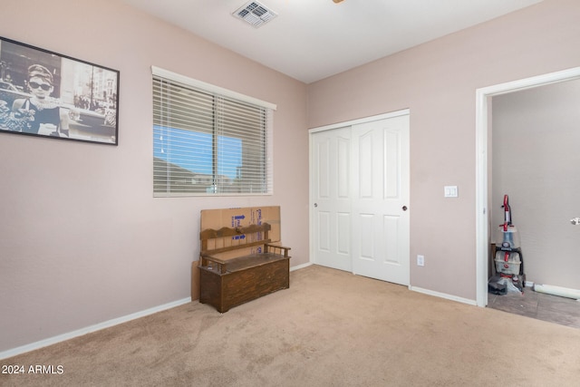 bedroom with a closet and light colored carpet