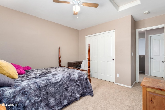 bedroom with a closet, ceiling fan, and light colored carpet