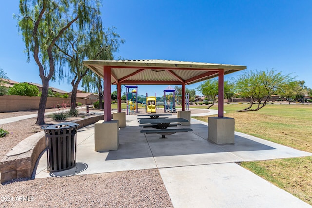 view of property's community featuring a gazebo, a lawn, and a playground