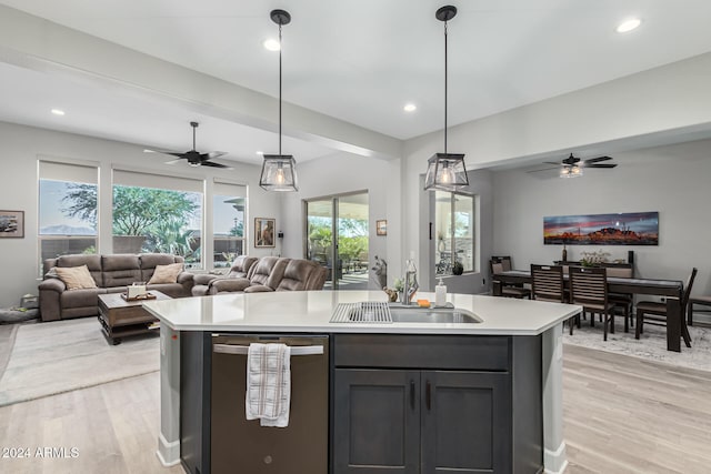 kitchen featuring light hardwood / wood-style floors, hanging light fixtures, stainless steel dishwasher, and sink