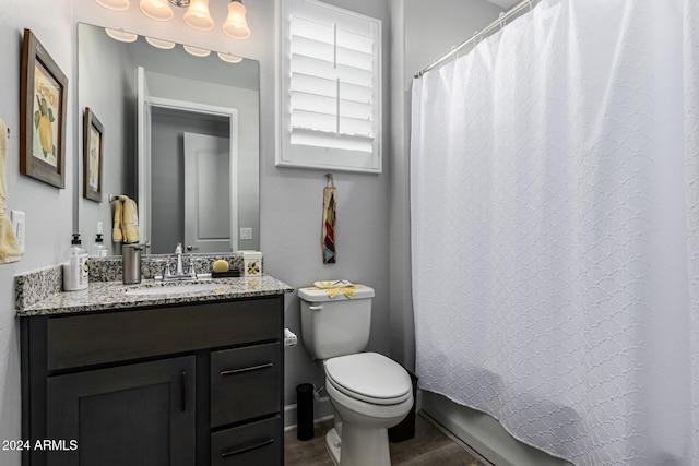 bathroom featuring hardwood / wood-style floors, curtained shower, vanity, and toilet