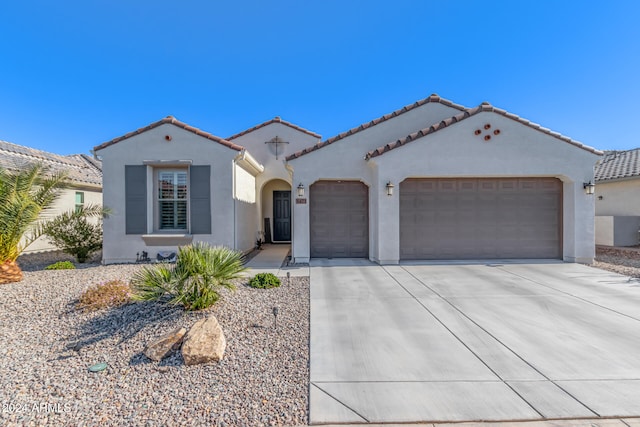 mediterranean / spanish-style home with a garage