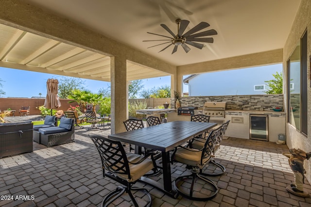 view of patio / terrace featuring a grill, beverage cooler, area for grilling, and ceiling fan