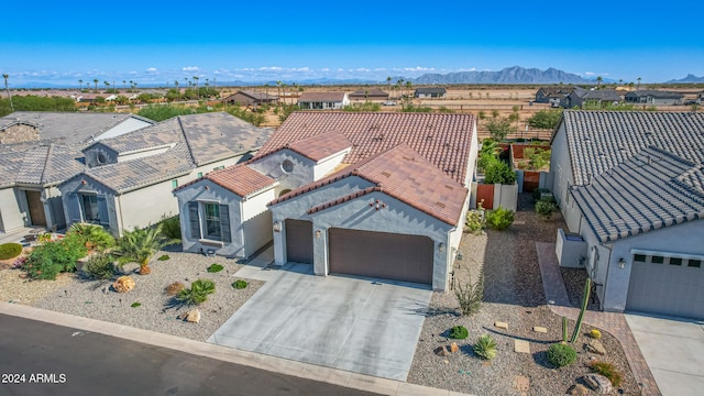 view of front of home with a garage and a mountain view