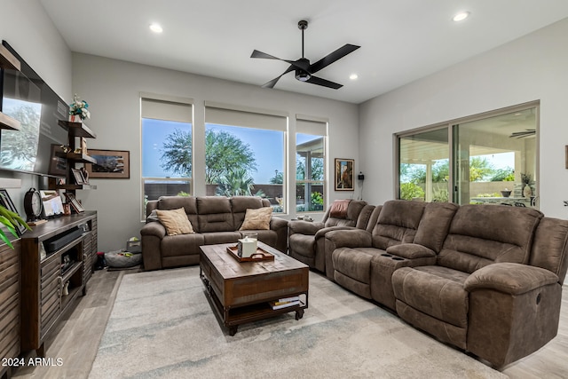 living room with ceiling fan and light hardwood / wood-style floors