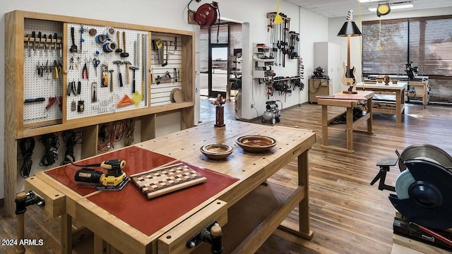 dining space with a workshop area and wood-type flooring