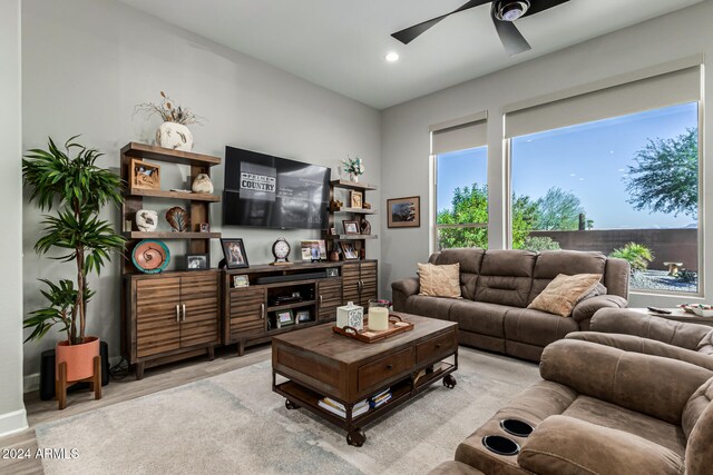 living room with ceiling fan and light hardwood / wood-style flooring