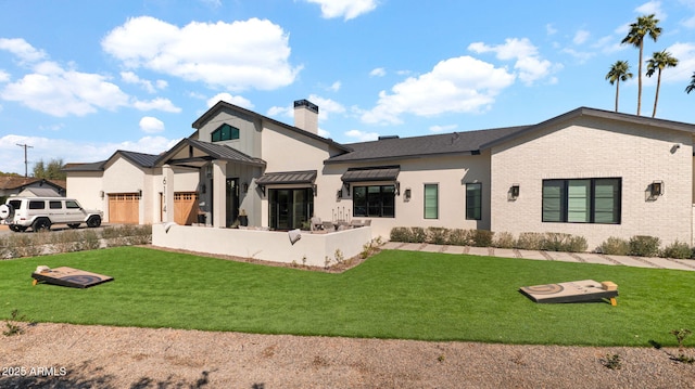 rear view of property featuring a standing seam roof, a yard, metal roof, brick siding, and a chimney