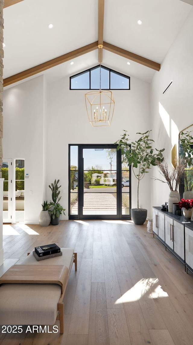 foyer featuring beamed ceiling, recessed lighting, an inviting chandelier, hardwood / wood-style flooring, and high vaulted ceiling