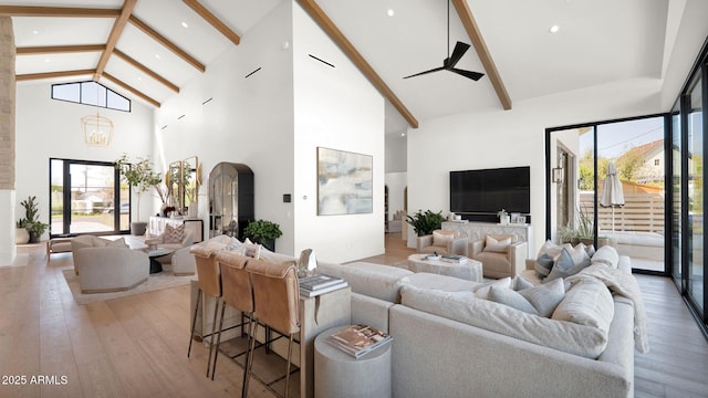 living area with light wood-style floors, arched walkways, and a wealth of natural light