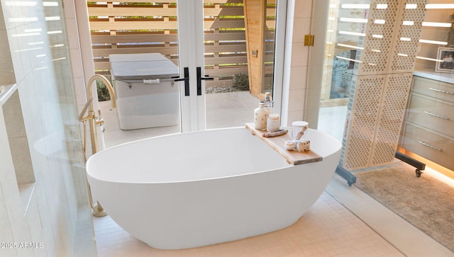 full bath with tile patterned floors and a freestanding tub