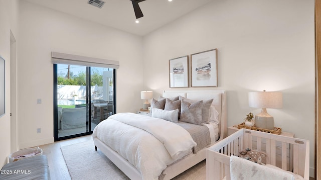 bedroom featuring light wood finished floors, visible vents, baseboards, recessed lighting, and access to outside