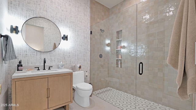 bathroom featuring vanity, tile walls, toilet, and a stall shower