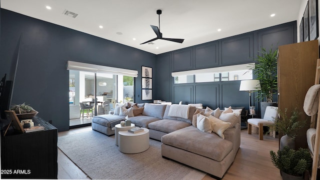 living room with recessed lighting, visible vents, a ceiling fan, and light wood finished floors