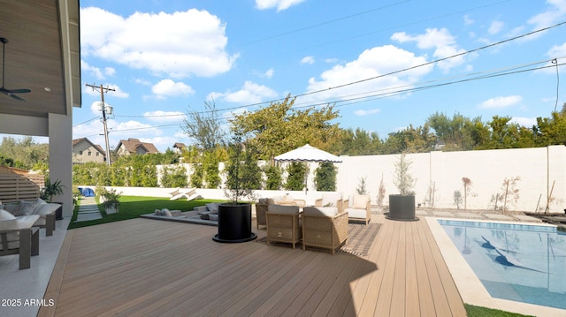 wooden terrace featuring an outdoor living space, a fenced in pool, and a fenced backyard