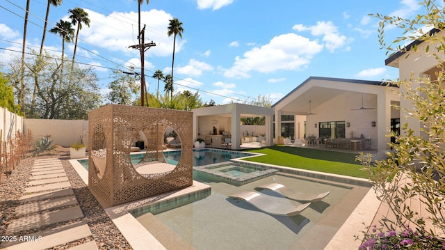 view of swimming pool with a patio, a fenced backyard, a fenced in pool, an in ground hot tub, and ceiling fan