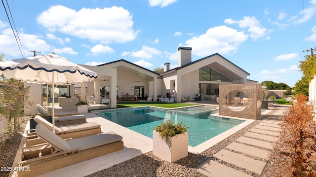 view of pool with an outdoor living space, a patio, and a pool with connected hot tub