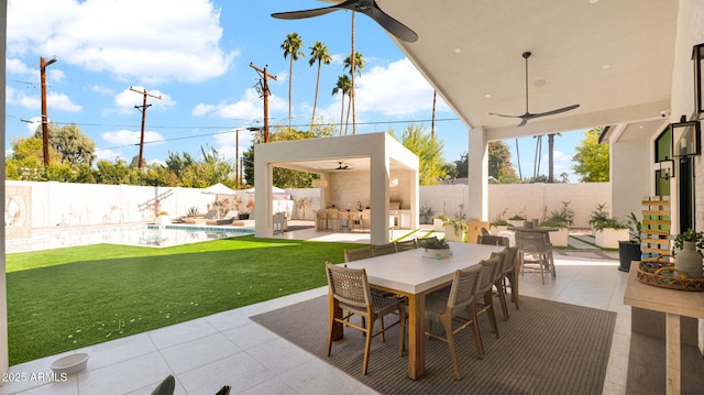 view of patio / terrace with a fenced in pool, a ceiling fan, a fenced backyard, and outdoor dining space