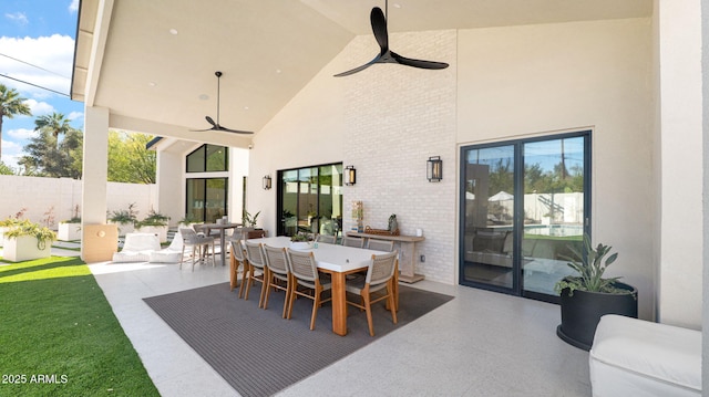 view of patio / terrace featuring a ceiling fan, outdoor dining area, and fence