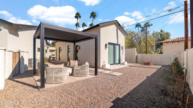 rear view of house with a fenced backyard, stucco siding, and a patio