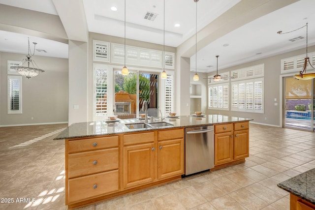 kitchen featuring a wealth of natural light, open floor plan, dishwasher, and a sink