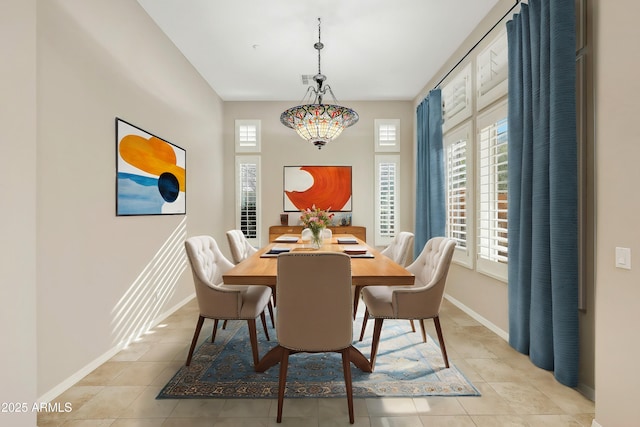 dining area featuring a wealth of natural light, light tile patterned flooring, and baseboards