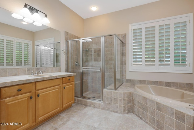 bathroom with vanity, a shower stall, a bath, and tile patterned floors