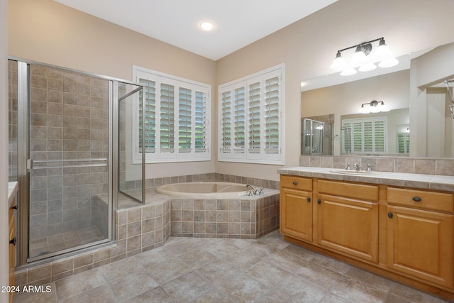 full bathroom featuring vanity, a shower stall, a bath, and tile patterned floors