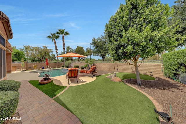 view of yard featuring a patio area, a fenced backyard, and a fenced in pool