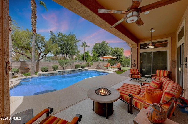 pool at dusk featuring an outdoor fire pit, a ceiling fan, a fenced in pool, a patio, and a fenced backyard