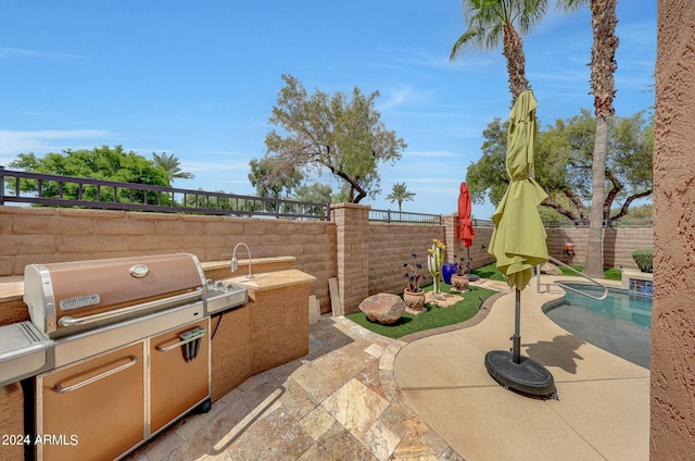 view of patio / terrace with a fenced backyard, a fenced in pool, and area for grilling