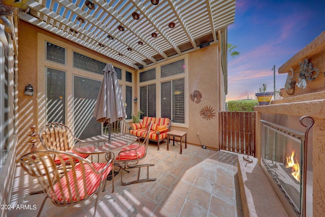 patio terrace at dusk with a pergola