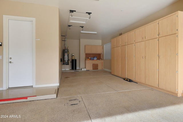 garage featuring gas water heater and baseboards