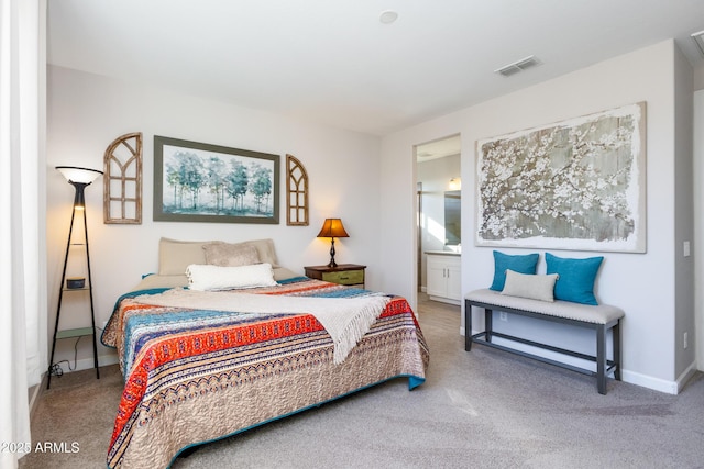 bedroom with carpet floors and ensuite bath