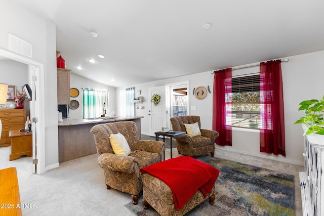 carpeted living room featuring lofted ceiling