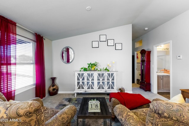 carpeted living room with vaulted ceiling