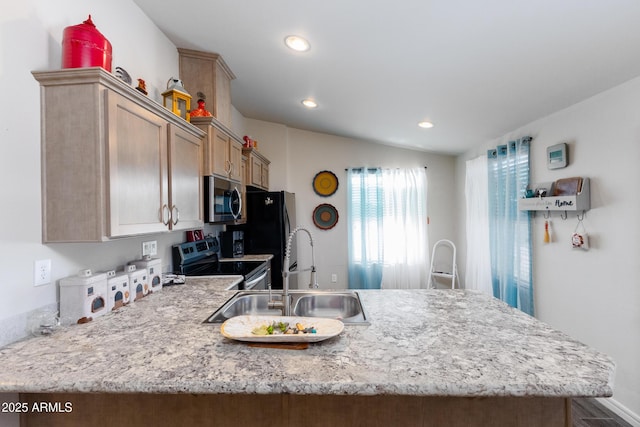 kitchen featuring sink, kitchen peninsula, stainless steel appliances, and vaulted ceiling