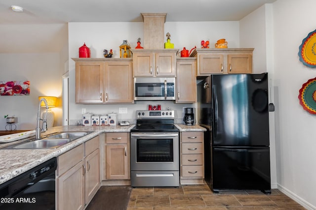 kitchen featuring black appliances, light stone countertops, sink, and light brown cabinetry