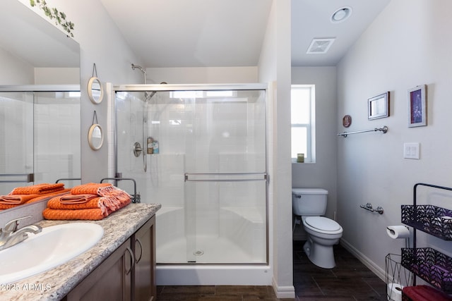 bathroom with vanity, an enclosed shower, and toilet