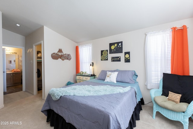 carpeted bedroom with vaulted ceiling and ensuite bath