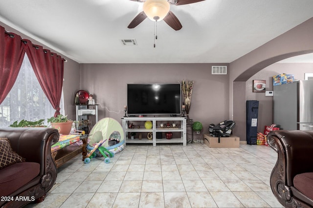 living room with light tile patterned floors and ceiling fan