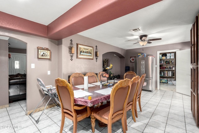 tiled dining room featuring ceiling fan