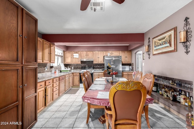 kitchen featuring electric range, ceiling fan, light tile patterned floors, tasteful backsplash, and stainless steel fridge with ice dispenser