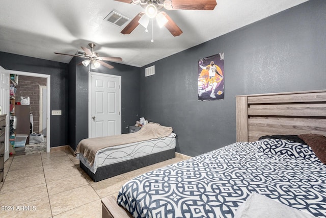 tiled bedroom with ceiling fan