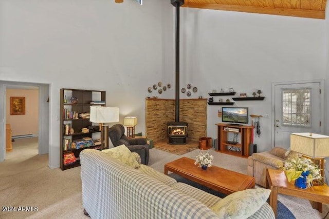 carpeted living room with a wood stove, high vaulted ceiling, wooden ceiling, and a baseboard heating unit