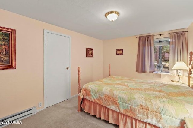 bedroom with carpet floors and a baseboard heating unit