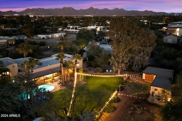 aerial view at dusk featuring a mountain view