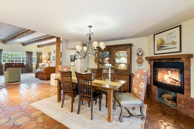 dining room with a chandelier and beam ceiling