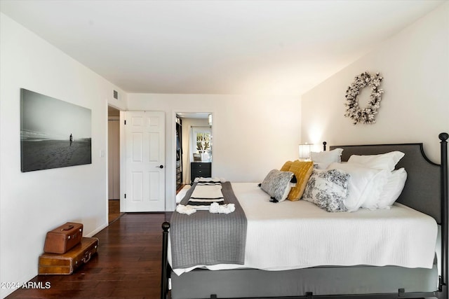 bedroom with dark hardwood / wood-style flooring